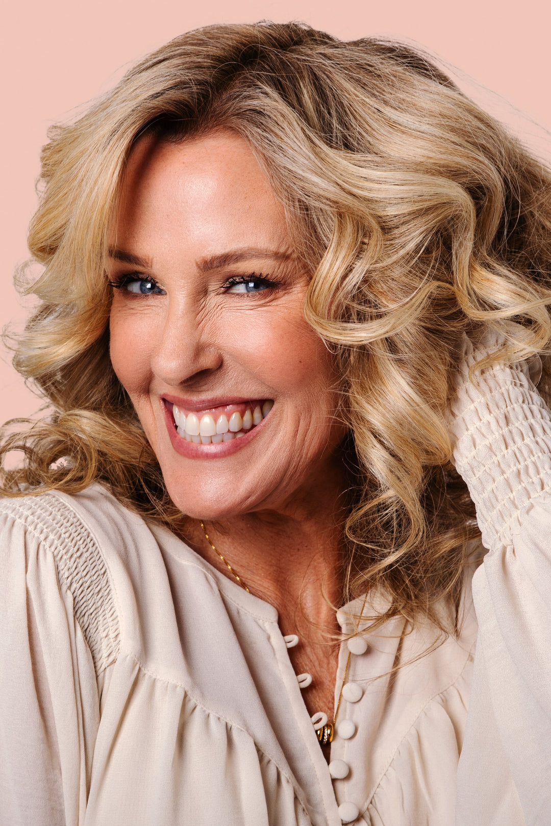 woman with defined curly hair smiling