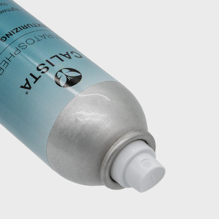 A close-up of a silver and blue STRATOSPHERE Texturizer Spray canister by Calista Tools, highlighting the nozzle and part of the logo against a plain, light background.