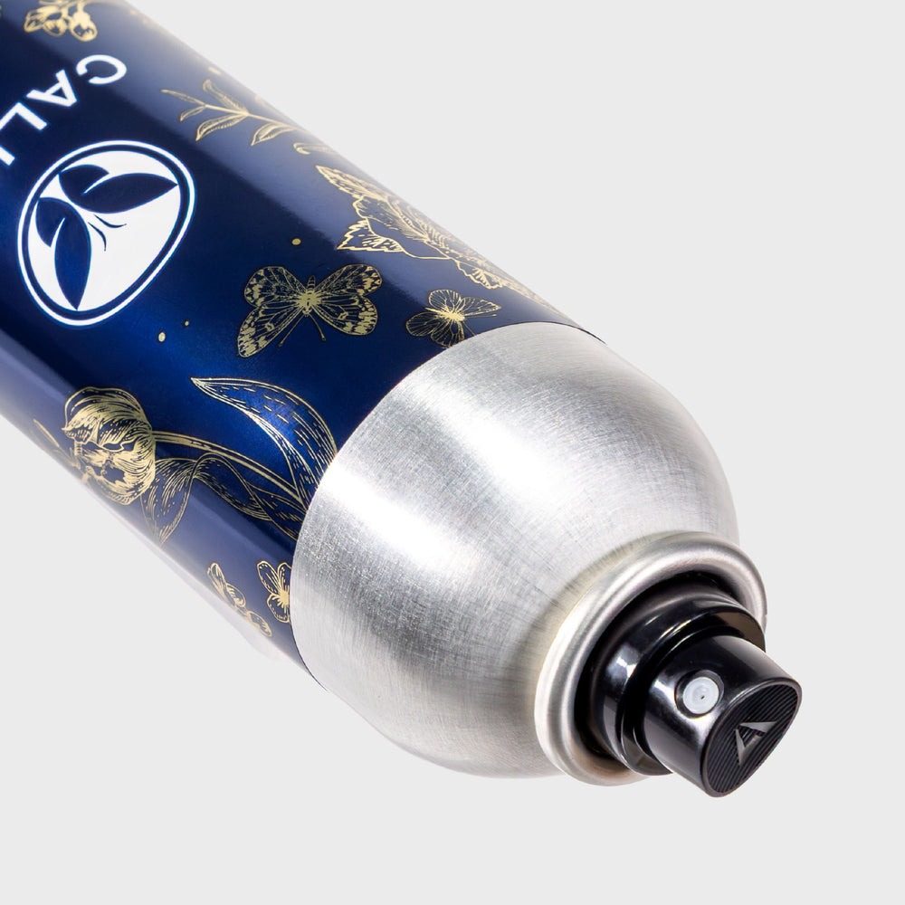 A close-up of the Calista Tools STRATOSPHERE Volumizing Duo can, with silver botanical and butterfly designs, metallic cap, and black nozzle, set against a light gray background.