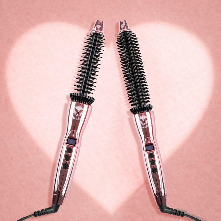 Two Perfecter Pro Short Hair Duo brushes by Calista Tools, with black bristles, are arranged in a heart shape on a pink background with a white heart outline—showcasing this essential styling tool for short hair.