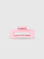 The Calista Claw Clip by Calista Tools is a large, light pink rectangular hair clip with a matte finish and wide teeth for a strong hold, shown against a plain light gray background.