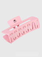 The Calista Claw Clip by Calista Tools is a large, light pink matte hair clip with wide, evenly spaced teeth and a rectangular shape. It features a small circular logo on the hinge and is shown against a plain light background.