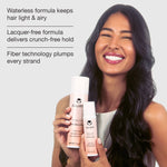 A smiling woman with long dark hair holds two Calista embellish finishing spray bottles against a light gray background, with promotional text on the left side.