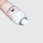 A close-up of a CALISTA Embellish Finishing Spray aerosol can, showing its pale pink body, white nozzle, and silver metal collar against a light gray background.