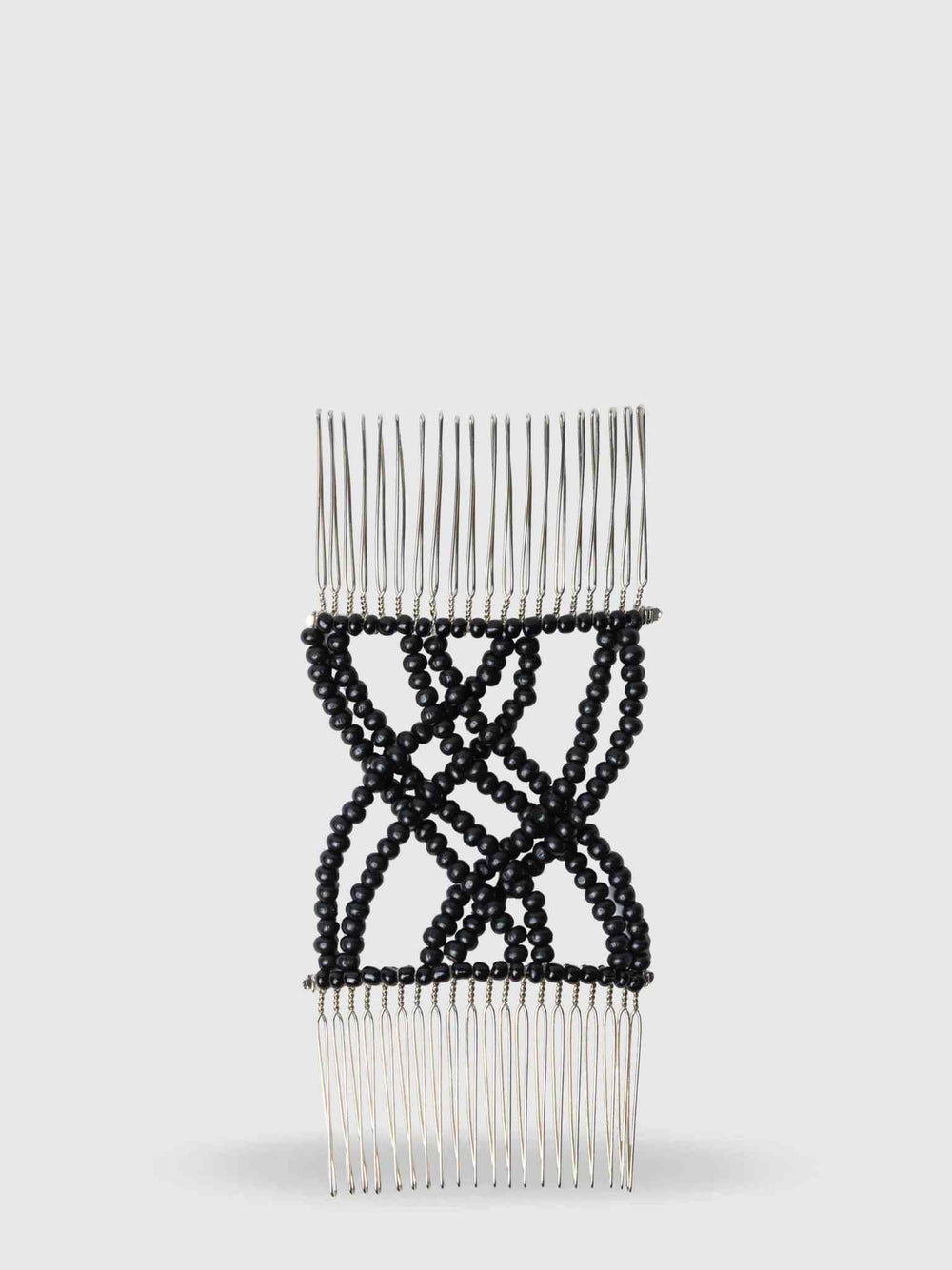 The Calista Tools FlipClip combines a double hair comb and hair clip with crisscrossed black beads, metal teeth on both ends, and detailed beadwork in the center for a strong, no-tangle hold.