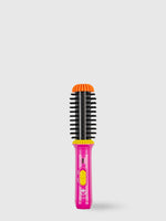 The Refurbished GoGo Mini Round Brush by Calista Tools, featuring pink and yellow accents with black bristles and an orange tip, stands upright against a plain light gray background, ready to de-frizz and volumize hair.
