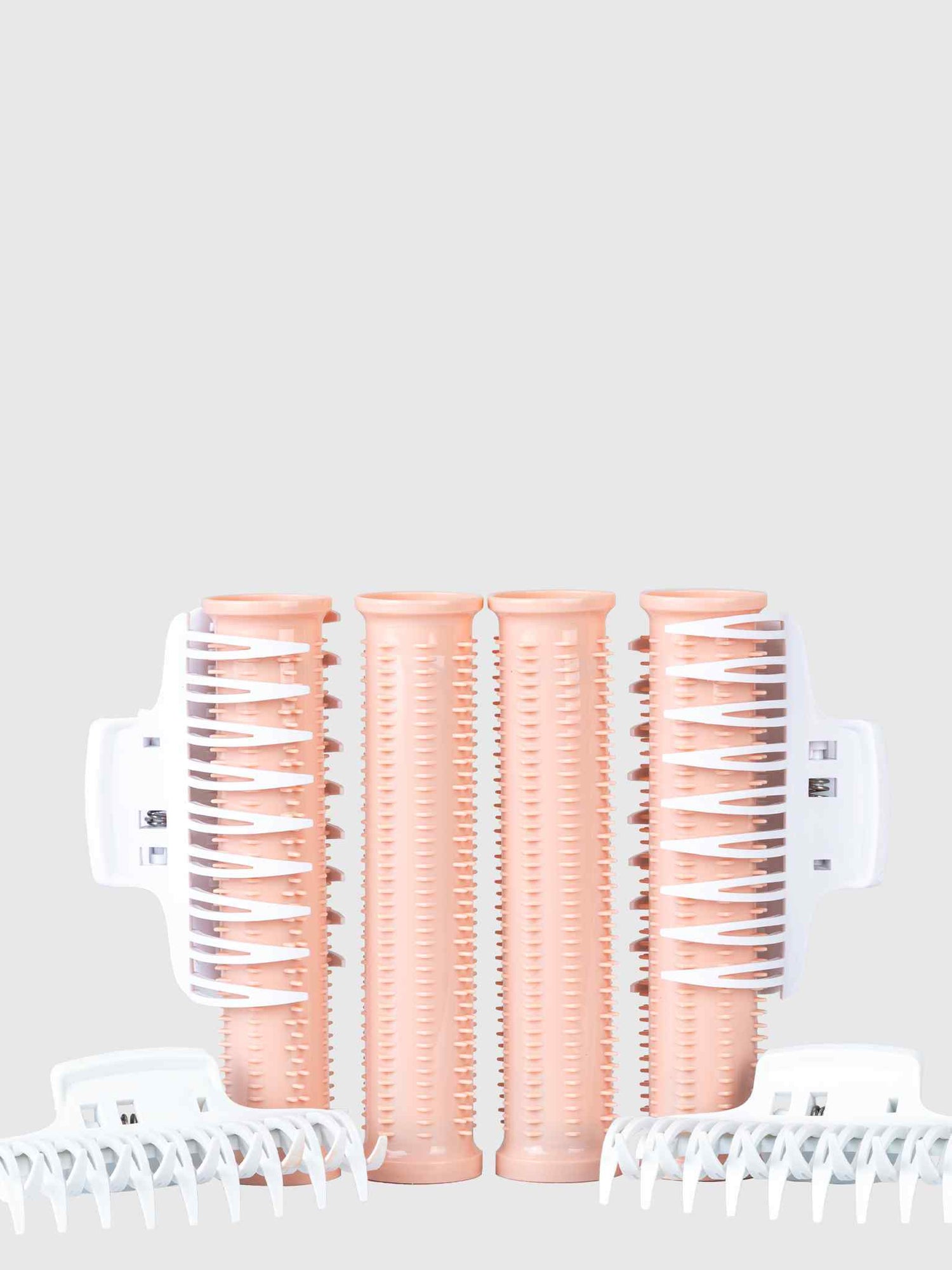 Four peach-colored Calista Tools Ion Hot Rollers Replacement Pack Long with bristles, featuring Ionic Technology for volume, are arranged vertically and flanked by four white clips—two on each side—on a light gray background.