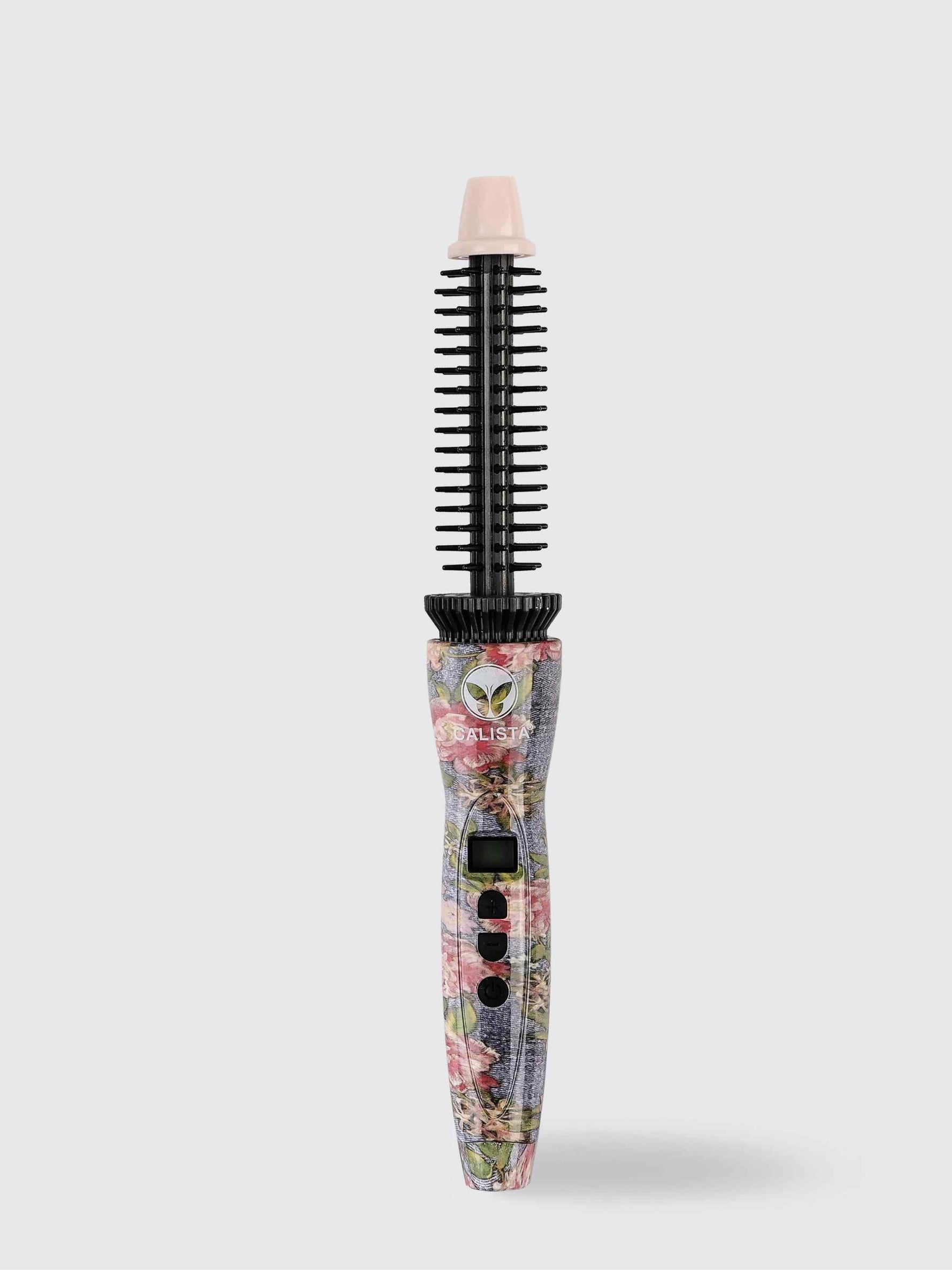 The Refurbished Perfecter Pro Heated Round Brush by Calista Tools features a floral pattern, black bristles, digital display, and control buttons—an elegant styling tool that stands upright against a plain light background.