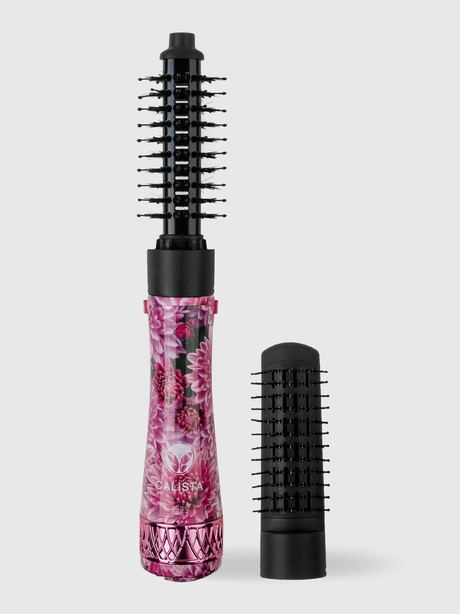 The Refurbished StyleDryer Pro Hair Drying Brush by Calista Tools features a floral pattern, black bristles, and comes with a detachable brush head, displayed on a light gray background.
