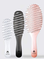 Three SMOOTHIE Brush Trio hairbrushes by Calista Tools in white, black, and rose gold stand upright. Each features a curved, vented design and the Calista logo on the handle for easy detangling and effortless hair styling. 